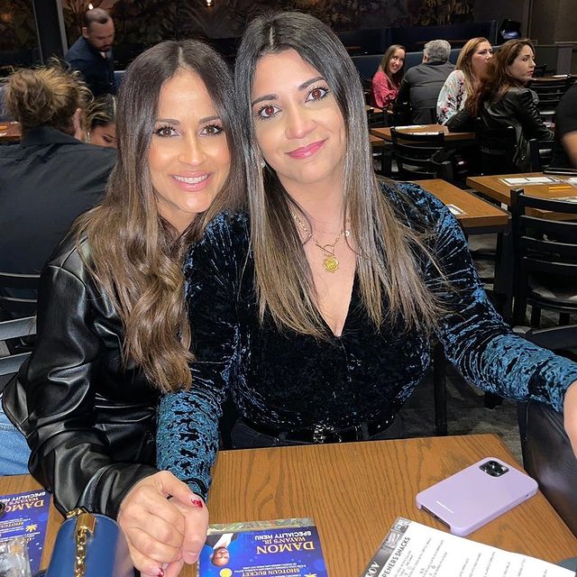 Jackie Guerrido in a black leather jacket with her daughter in shiny blue velvet top.